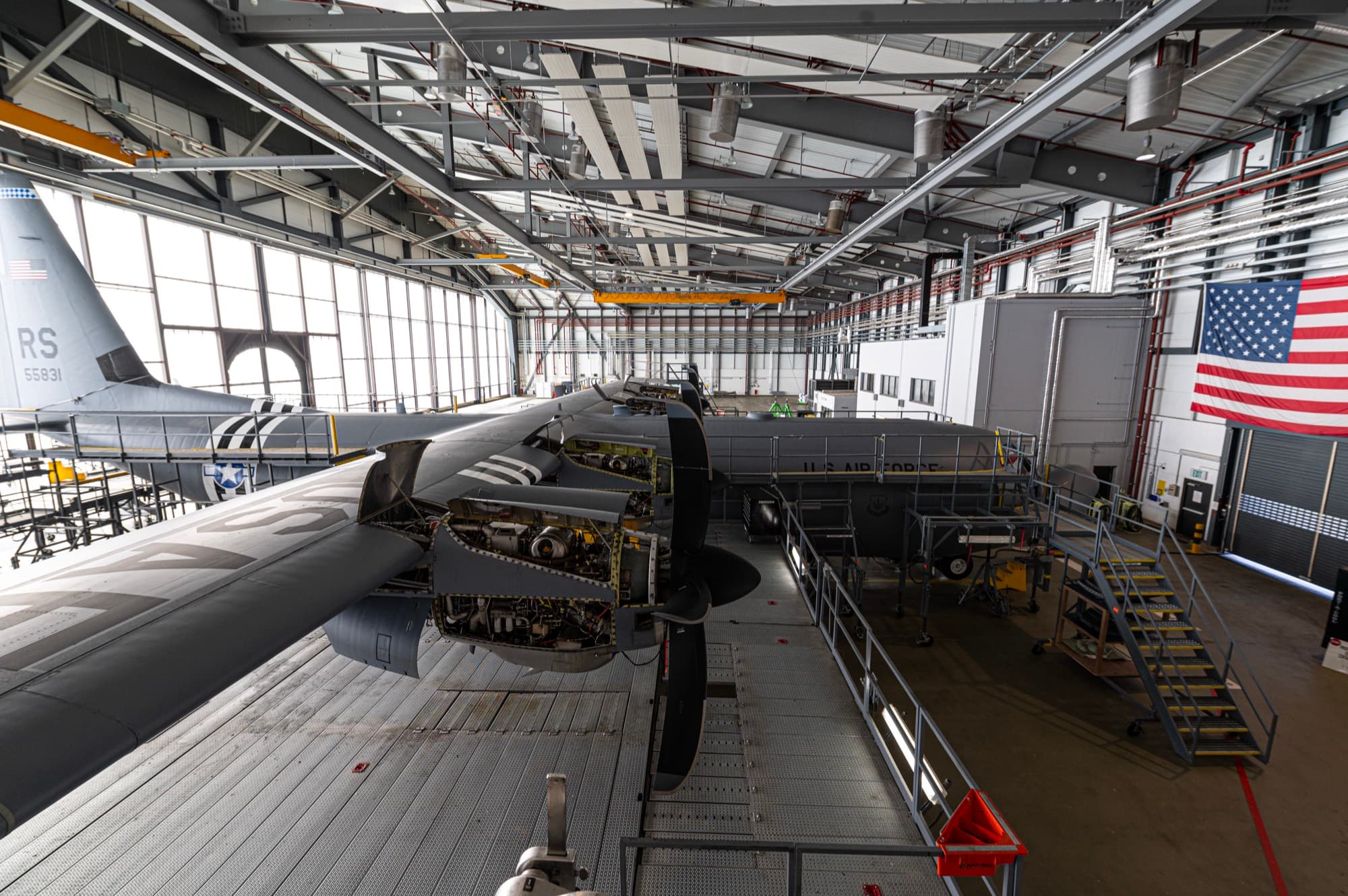 Aircraft undergoing deep inspection inside a maintenance hangar
